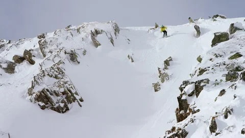 Adventurous skier making turns while skiing down the mountain Stock Footage 116741220