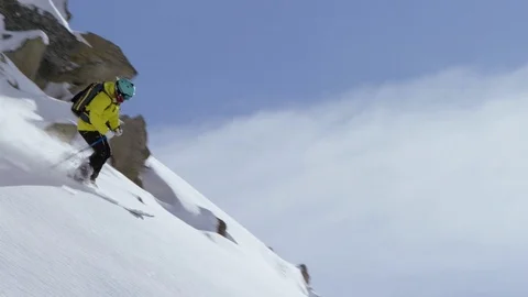 Adventurous skier making turns while skiing down the snowy mountain slope Stock Footage 116741331