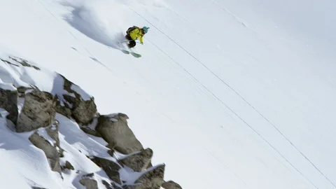 Adventurous skier making turns while skiing down the snowy mountain slope Stock Footage 116741874