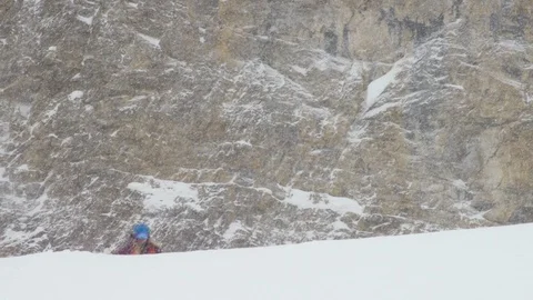 Adventurous skier making turns while skiing snowy downhill Stock Footage 116744912