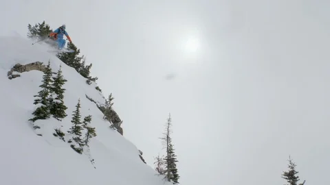 Adventurous skier skiing and jumping through the snow covered slopes Stock Footage 116631298