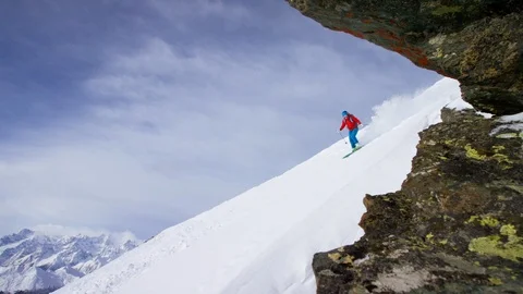 Adventurous skier skiing down the snowy mountain slope Stock Footage 116743374
