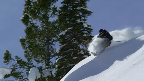 Adventurous skier speedily skiing down the snowy mountain slope Stock Footage 116738973