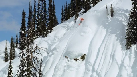 Adventurous snowboarder jumping downhill on steep snow mountain slope Stock Footage 116788700