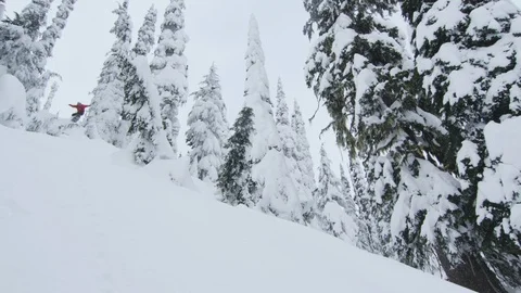 Adventurous snowboarder jumping on snow covered mountain slope Stock Footage 116782989