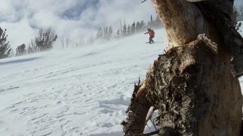 Adventurous snowboarder shredding down the mountain Stock Footage 116744602