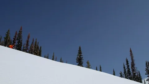 Adventurous snowboarder shredding down snowy mountain slope during winter Stock Footage 116788859