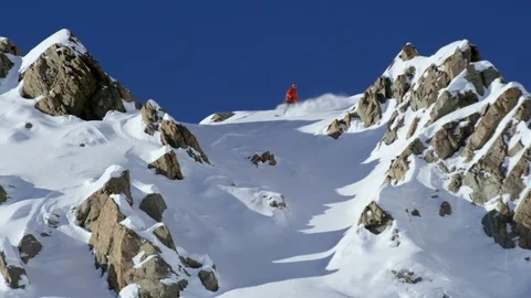 Adventurous snowboarder snowboarders sliding down snowy mountain Stock Footage 116748366