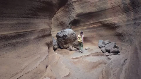 Adventurous woman exploring the geological formations of the Las Vacas canyon Stock Footage 346025186