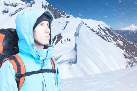 Adventurous young man with backpack standing on mountain top view and looking Stock Photos