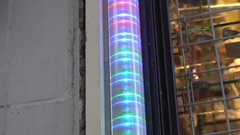 An advertisement light that blinks in multiple colors. Around you can see Vídeos de archivo 121040541