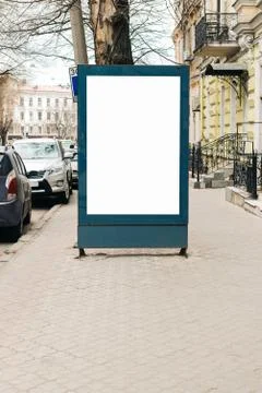 Advertising blank billboard on the sidewalk in the old city Stock Photos