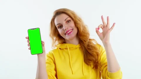 Advertising, green screen, chroma key, OK gesture and woman with phone for produ Stock Footage 257539194