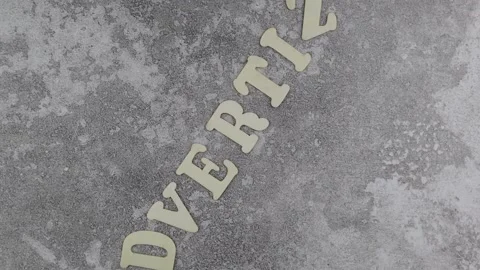 Advertize concept with offset alphabet letters on textured grey background Vídeo Stock 150787311