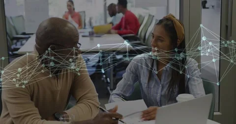 Advisor pointing document triggers network overlay while intern jotting notes Video stock 317207119