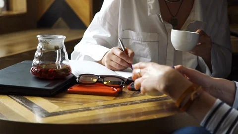 Advisor Taking Notes while Meeting with Client Stock Footage 110042150