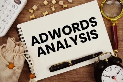AdWords Analysis text written on notepad with pen, alarm clock, magnifying .. Stock Photos
