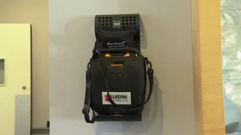 AED - Automated Electronic Defibrillator Mounted on Wall Stock Footage 230651222
