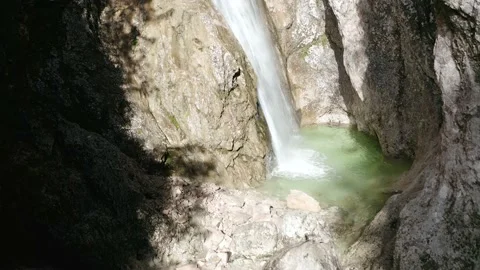 Aeiral Shot of Small Waterfall Pool Squeezed Between Large Walls. Video stock 168139793