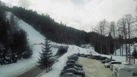 Aeiral view of skiers down the ski slope and car parking, Borovets, Bulgaria Stock Footage 108753480