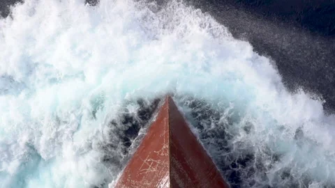 Aerail view of the bow of a ship sailing at sea and creating splashes of sea. Stock Footage 140658620