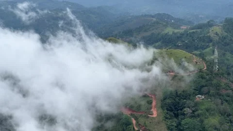 Aeral Tilt shot with cloud rolling down a mountain in Sri Lanka Video stock 261577152