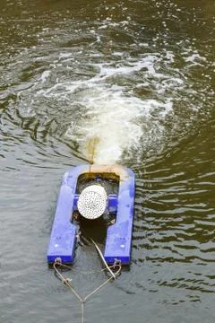 Aeration machine working in water. Stock Photos