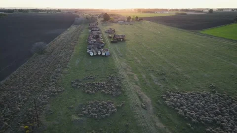 Aereal panoramic view of a Train graveyard in a field at sunset Stock Footage 217297652