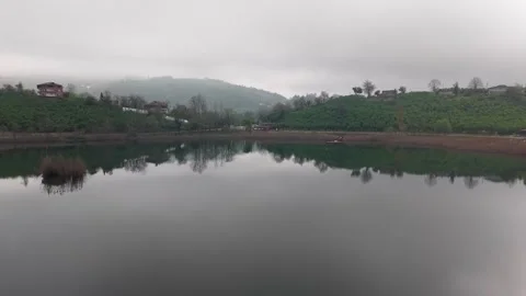 Aerial 4K 60fps Low Flyover Calm Lake Reflection Houses Stock Footage 335598351