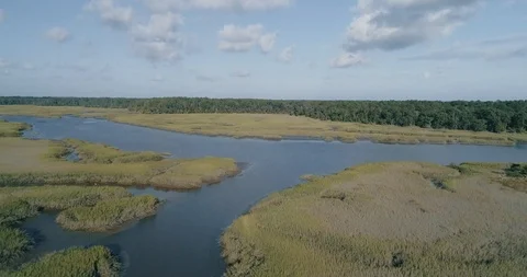 Aerial 4k bird chase down waterway with tilt Video stock 89785375
