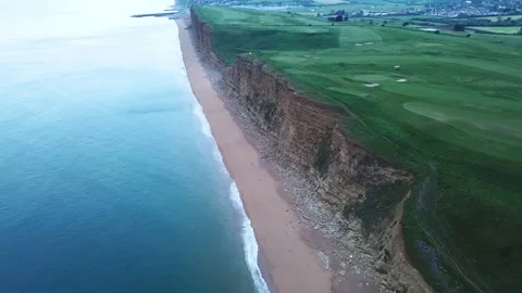 Aerial 4K Bird Eye View of Bridport West Bay Cliffs Above British Seaside Stock Footage 229833554