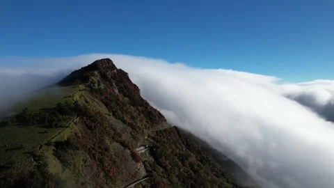 Aerial 4K Cloud Waterfall Flowing Over Mt Kamegamori Ridge Japan Drone Video stock 344833344