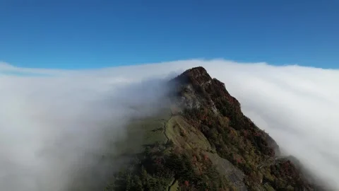 Aerial 4K Cloud Waterfall Flowing Over Mt Kamegamori Ridge Japan Drone Video stock 344833378