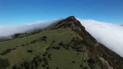 Aerial 4K Cloud Waterfall Flowing Over Mt Kamegamori Ridge Japan Drone Video stock 344834017