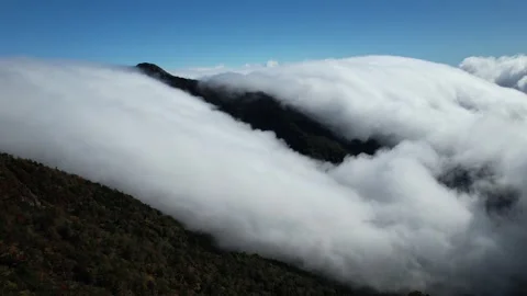Aerial 4K Cloud Waterfall Flowing Over Mt Kamegamori Ridge Japan Drone Video stock 344834049