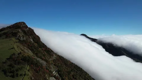 Aerial 4K Cloud Waterfall Flowing Over Mt Kamegamori Ridge Japan Drone Video stock 344834050