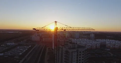 Aerial 4K: Construction crane on construction site at sunset Stock Footage