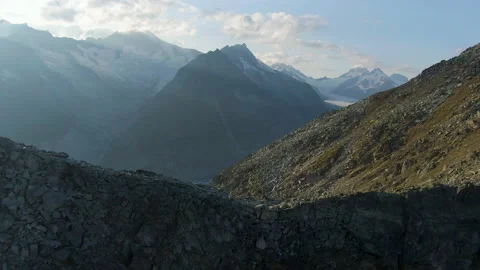 Aerial 4k dramatic reveal shoot of Aletsch Glacier in the Swiss Alps Stock Footage 146097696