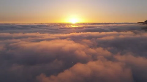 Aerial 4K Drone Flight Above Clouds at Sunset with Sun in Frame – Relaxing Stock Footage 314600715