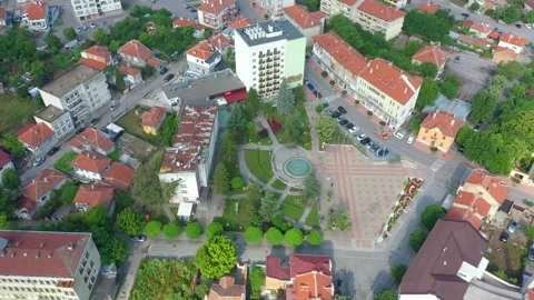 Aerial 4K drone flight over a typical European provincial Balkan town Stock Footage 240761478