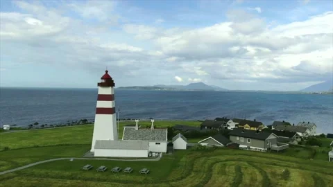 Aerial 4k drone shot of red-white lighthouse on the edge of Norway with the o Stock Footage 138721145