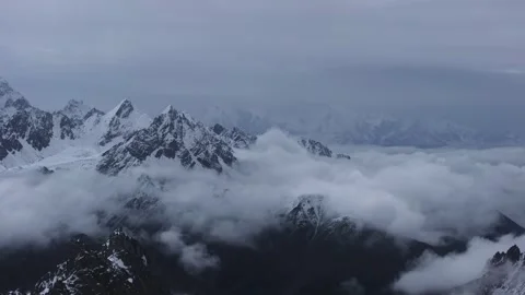 Aerial 4K Drone Time-lapse of Majestic Snow Mountain Peaks and Epic Clouds Stock Footage 336857436