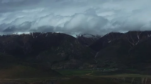 Aerial 4K Drone Time-lapse Thick Rolling Clouds Over Dark Mountain Forest Stock Footage 336857700