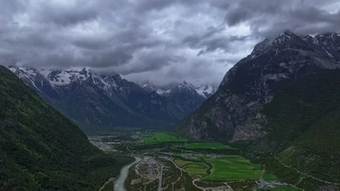 Aerial 4K Drone Time-lapse Thick Rolling Clouds Over Dark Mountain Forest Stock Footage 336857728