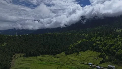 Aerial 4K Drone Time-lapse Thick Rolling Clouds Over Dark Mountain Forest Stock Footage 336857751