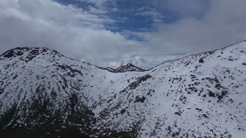 Aerial 4K Drone Time-lapse of Majestic Snow Mountain Peaks and Epic Clouds Stock Footage 336857783