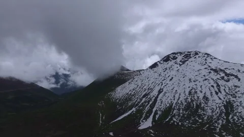 Aerial 4K Drone Time-lapse of Majestic Snow Mountain Peaks and Epic Clouds 動画素材 336857810