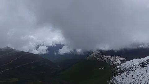 Aerial 4K Drone Time-lapse of Majestic Snow Mountain Peaks and Epic Clouds Video stock 336857891