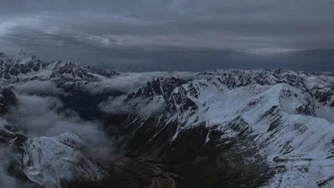 Aerial 4K Drone Time-lapse of Majestic Snow Mountain Peaks and Epic Clouds Video stock 336858392