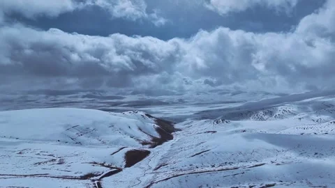 Aerial 4K Drone Time-lapse of Majestic Snow Mountain Peaks and Epic Clouds Stock Footage 336923325